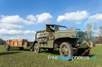 Military Army Jeep Pulling Trailer On Grass Stock Photo