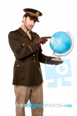 Military Officer Pointing Something On Globe Stock Photo