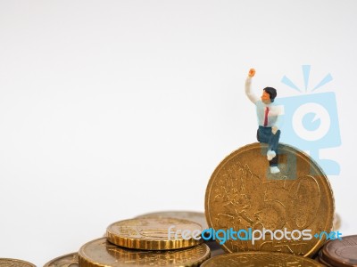 Miniature Businessman Stand On Euro Coins And Book Bank. Busines… Stock Photo