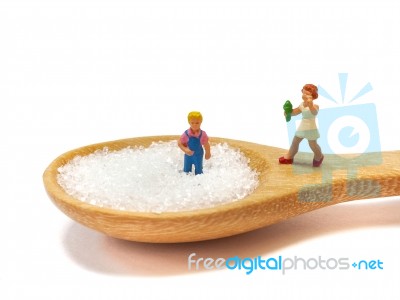 Miniature Little Children Standing On A Wooden Spoon And Thinking Of Sugar, Diet, Fat And Diabetes. Health Care Concept Stock Photo