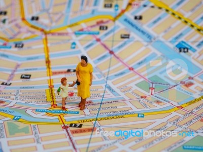 Miniature Mother And Little Girl Stand On Map. Travelling Concep… Stock Photo