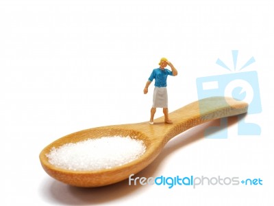 Miniature Woman Standing On A Wooden Spoon And Thinking Of Sugar, Diet, Fat And Diabetes. Health Care Concept Stock Photo