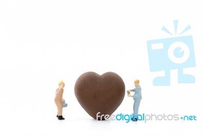 Miniature Worker Making Heart Shaped Chocolate On White Background , Stock Photo