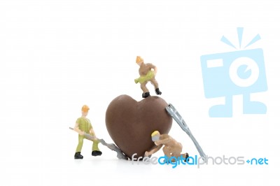 Miniature Worker Making Heart Shaped Chocolate On White Background , Stock Photo
