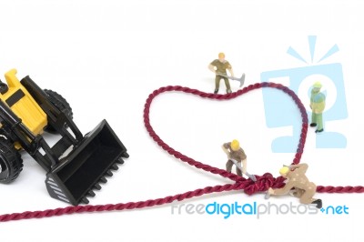 Miniature Worker Team Building Heart Shaped With Rope Stock Photo
