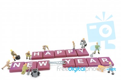 Miniature Worker Team Building Word Happy New Year On White Background Stock Photo