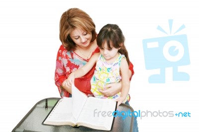 Minority Woman And Her Daughter Reading The Bible Stock Photo