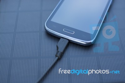 Mobile Phone Charging With Solar Energy - Charger Stock Photo