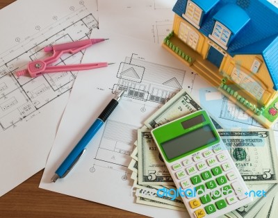 Modelhouse, Calculator And Us Dollars On Construction Planning Stock Photo