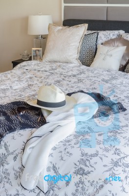 Modern Bedroom With Hat, Sunglass, And Clothes On Blanket Stock Photo