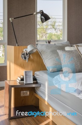 Modern Bedroom With Wooden Bed And Table Side Stock Photo