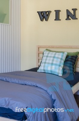 Modern Wooden Bed With Pillows And Blanket In Bedroom Stock Photo