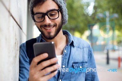 Modern Young Man With Mobile Phone In The Street Stock Photo
