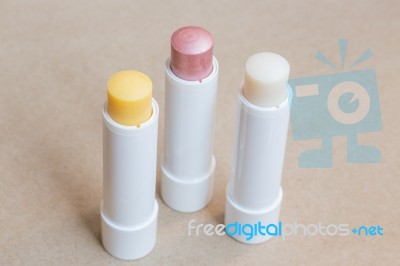 Moisturizer Lipstick On Brown Natural Background Stock Photo