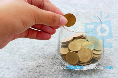 Money In Hand And Money In Glass Stock Photo
