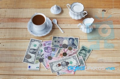 Money On Wooden Panel With Coffee Set Stock Photo