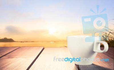 Morning Cup Of Coffee With River Background At Sunrise Stock Photo
