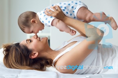 Mother And Baby Playing And Smiling At Home Stock Photo