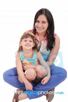 Mother And Daughter Sitting On The Floor And Hugging Each Other Stock Photo