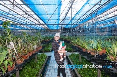 Mother And Her Son In The Greenhouse Stock Photo