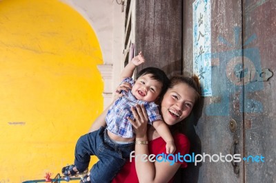 Mother And Son Standing At The House Stock Photo