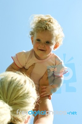 Mother lifting Her Child Stock Photo