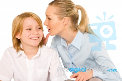 Mother Whispering To Son Close Up On White Background Stock Photo