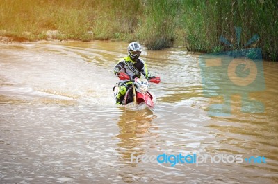 Motocross Is Trying To Drive Across The River Stock Photo
