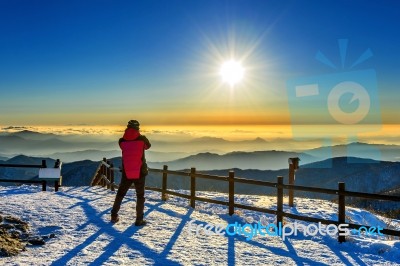 Mountaineer Stands On The Peak In Winter,deogyusan National Park In South Korea And Watching To Sunrise. Beautiful Moment The Miracle Of Nature Stock Photo