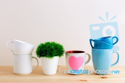 Mug And Cup Stack On Kitchen Table Stock Photo