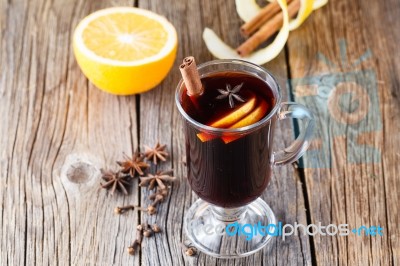 Mulled Wine And Spices On Weathered Wooden Table Stock Photo