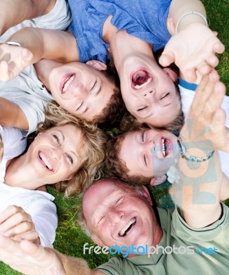 Multi-generation Family Lying In Circle Stock Photo