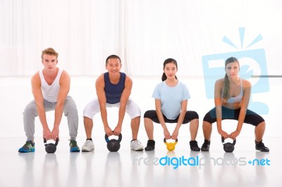 Multiethnic Group Of People Doing Kettlebell Crossfit Exercise Stock Photo