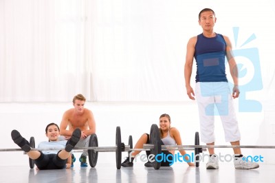 Multiethnic Group Of People Resting After Workout In Gym Stock Photo