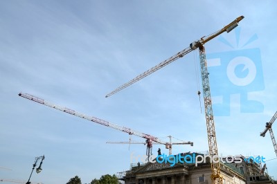 Multitude Of Cranes Above St. Hedwig's Cathedral In Berlin Stock Photo