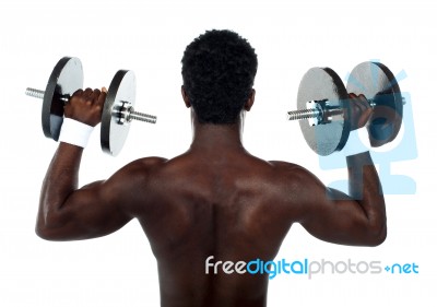 Muscular Man Lifting Dumbbell Stock Photo