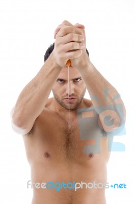 Muscular Man Posing With Dagger Stock Photo