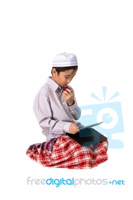 Muslim Boy Eating Stock Photo