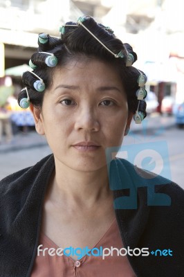 Natural Face Of Young Woman Dressing Her Hair Stock Photo