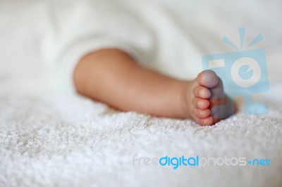 New Born Baby Foot On White Blanket Stock Photo