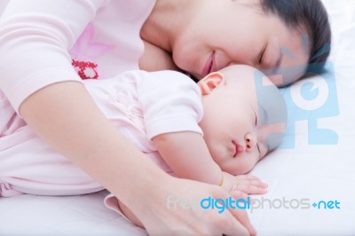 Newborn Baby Girl Sleeping In Mother Arm Stock Photo