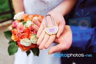 Newlyweds Hold The Lock Stock Photo
