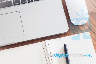 Notepad And Laptop On Wood Table Stock Photo