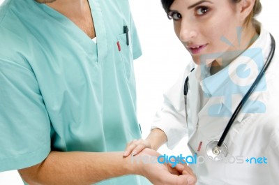 Nurse Checking Pulse Of Patient Stock Photo