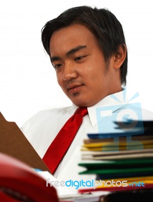 Office Manager Reviewing Reports Stock Photo