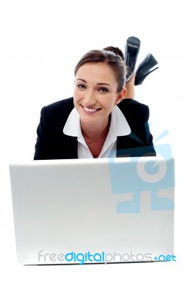 Office Woman Lying Down On Floor And Working Stock Photo