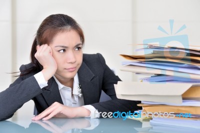 Office Worker In Office With Many Folders Stock Photo