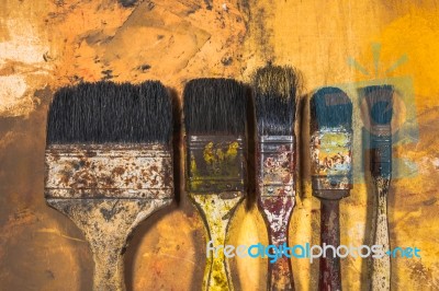 Oil Paint Brushes On Wood Painted Background Stock Photo