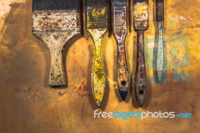 Oil Paint Brushes On Wood Painted Background Stock Photo