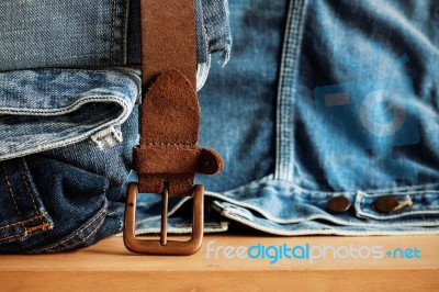 Old Belt And Jeans On Wooden Stock Photo